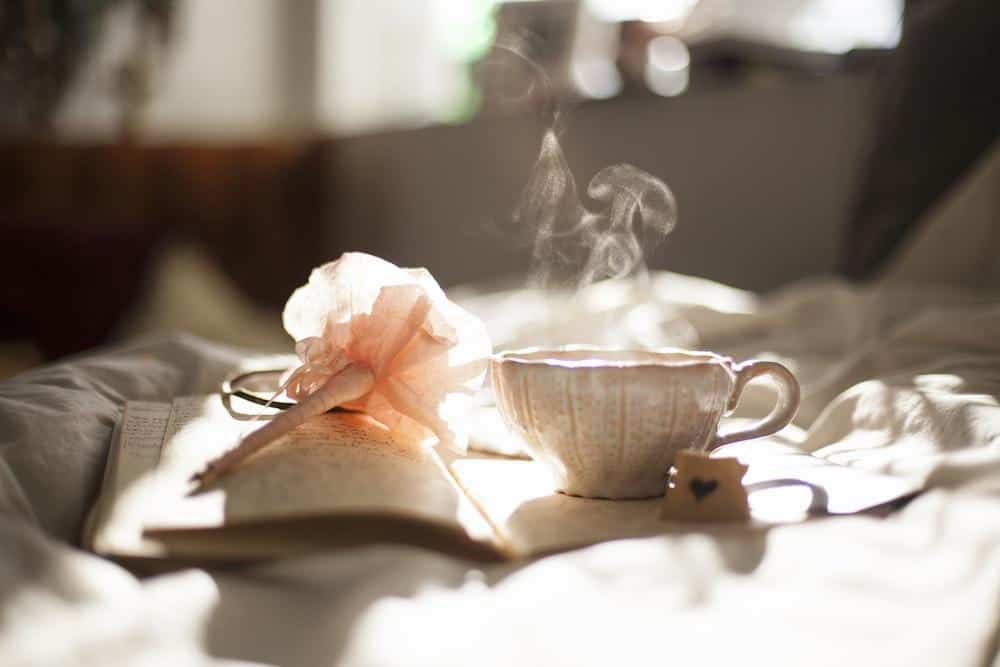 Delightful arrangement of roses displayed near a cup of freshly brewed coffee