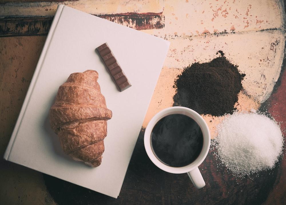 Traditional german coffee cake dusted with powdered sugar and a side of brewed coffee