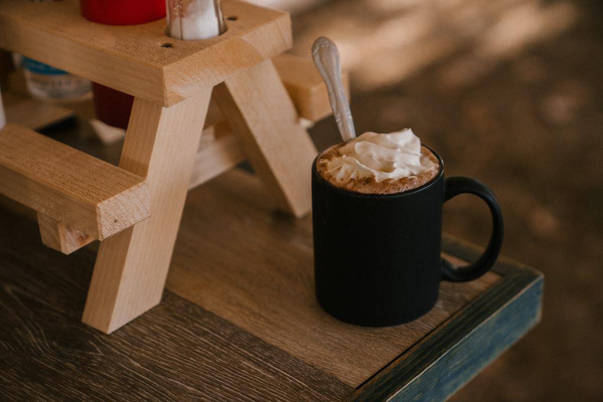 Indulging in a hot cup of coffee with a luscious topping of whipped cream